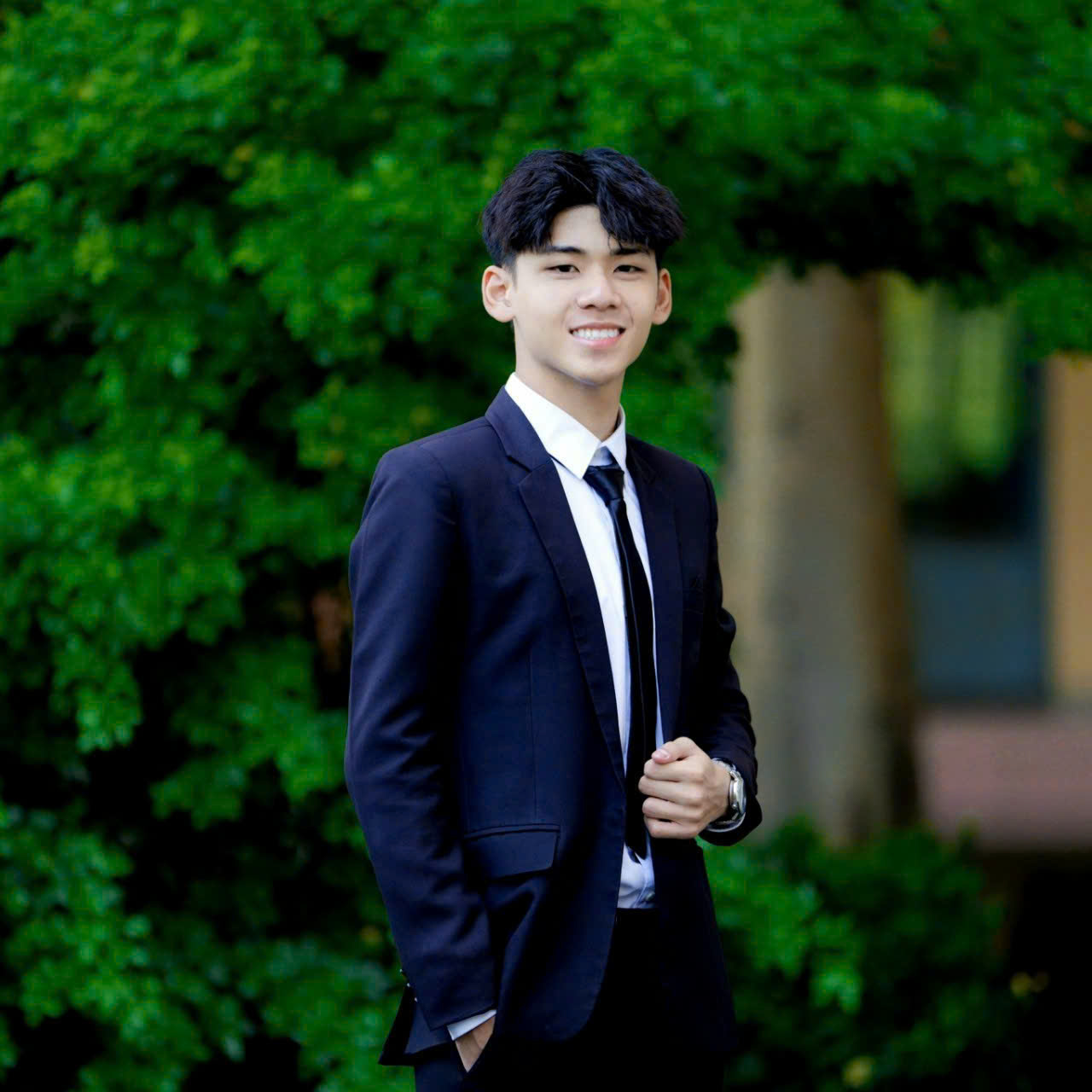 Nguyễn Trần Trọng Nghĩa standing at Nguyen Van Linh high school